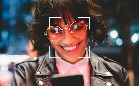 Woman using the face unlock feature of her Y62 Plus smartphone