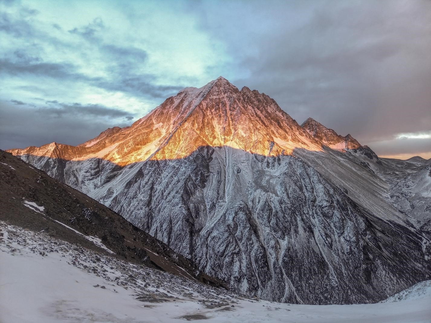 Photo of a sunrise on a snowy mountain